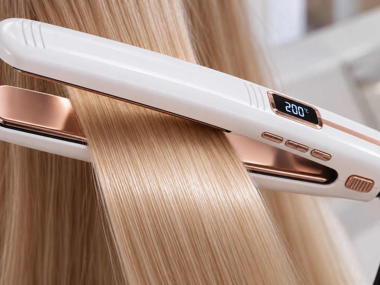 Extreme close-up of the smooth rose-gold titanium plates with blonde hair gliding over the surface